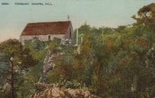 Load image into Gallery viewer, Vintage postcard of a small building on Chapel Hill in Torquay, surrounded by trees and greenery.
