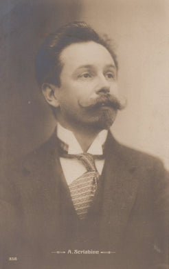 Vintage postcard of a man with a mustache wearing a suit and tie.