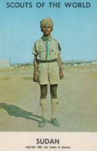 Load image into Gallery viewer, Scout in uniform with a turban standing on a road, with text &#39;Scouts of the World Sudan&#39; at the bottom.
