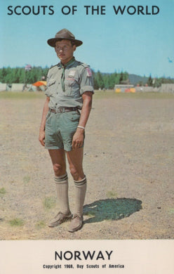Scout in uniform standing on a grassy field with 'Scouts of the World' and 'Norway' text at the top.
