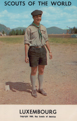 Vintage photograph of a scout in Luxembourg with mountains in the background