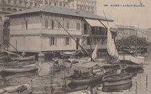 Load image into Gallery viewer, Vintage black and white photo of a waterfront scene with boats and a building in Algèr.
