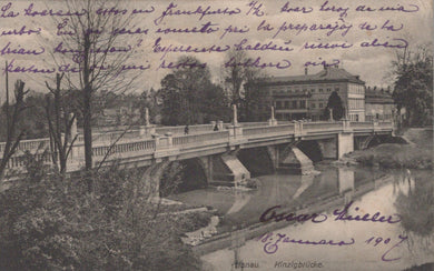 Vintage postcard of a bridge over a river with trees and buildings in the background