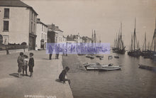 Load image into Gallery viewer, Vintage photograph of children by a harbor with boats and buildings in the background

