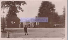 Load image into Gallery viewer, Vintage black and white photo of a person standing in front of a gate at Sutton Park, with &#39;Mo&#39;s Postcards&#39; watermark.
