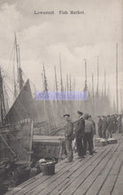 Load image into Gallery viewer, Vintage black and white photograph of a fish market in Lowestoft with people and boats.

