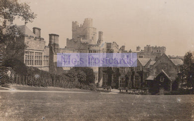 Historic black and white photograph of a large castle or manor house with surrounding grounds.