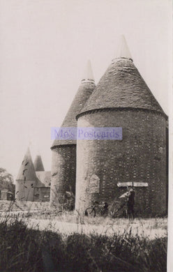 Two oast houses with a bicycle in front, labeled 'No Postcards'.