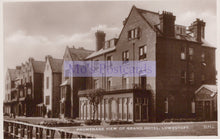 Load image into Gallery viewer, Vintage black and white postcard of a promenade view of the Grand Hotel in Lowestoft.
