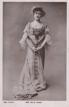 Load image into Gallery viewer, Vintage black and white photograph of a woman in an ornate dress against a plain background
