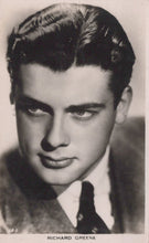 Load image into Gallery viewer, Black and white portrait of a man with styled hair, wearing a suit.
