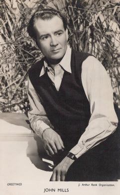 Black and white portrait of a man in a vest and shirt against a natural background