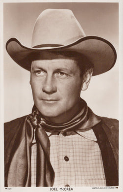 Black and white portrait of a man wearing a cowboy hat and scarf.