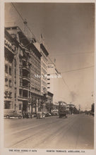 Load image into Gallery viewer, Vintage black and white photo of a city street with buildings and car 
