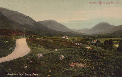 Scenic view of a valley with mountains and a road, featuring sheep and a postcard-like border.