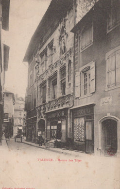 Vintage street scene with a building facade in Valence, featuring 'La Maison des Têtes'.