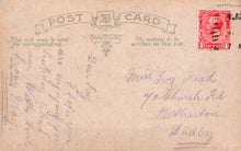 Load image into Gallery viewer, Vintage postcard with text and a stamp on a brown background
