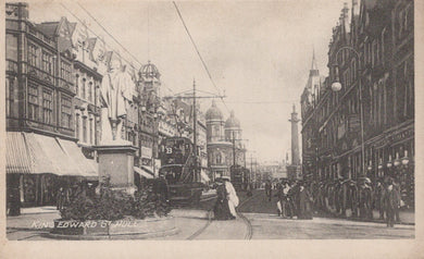 Vintage black and white photograph of a city street with pedestrians and buildings.