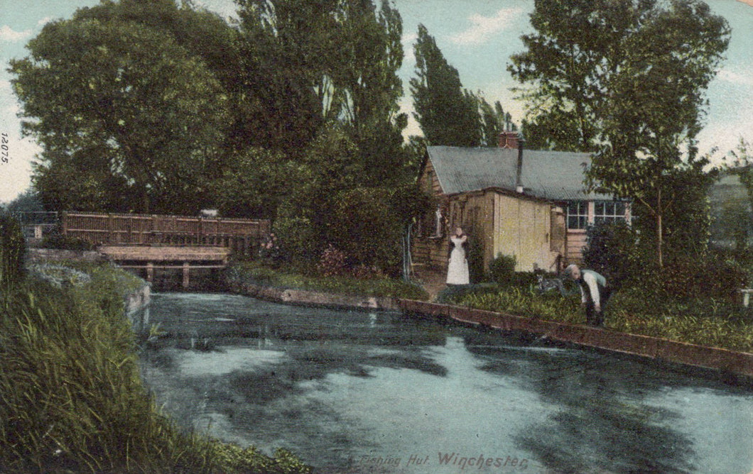 Vintage postcard of a canal scene with a houseboat and people by a wooden bridge.
