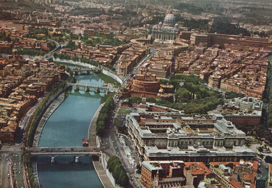 Aerial view of a cityscape with a river and prominent buildings, including a basilica.