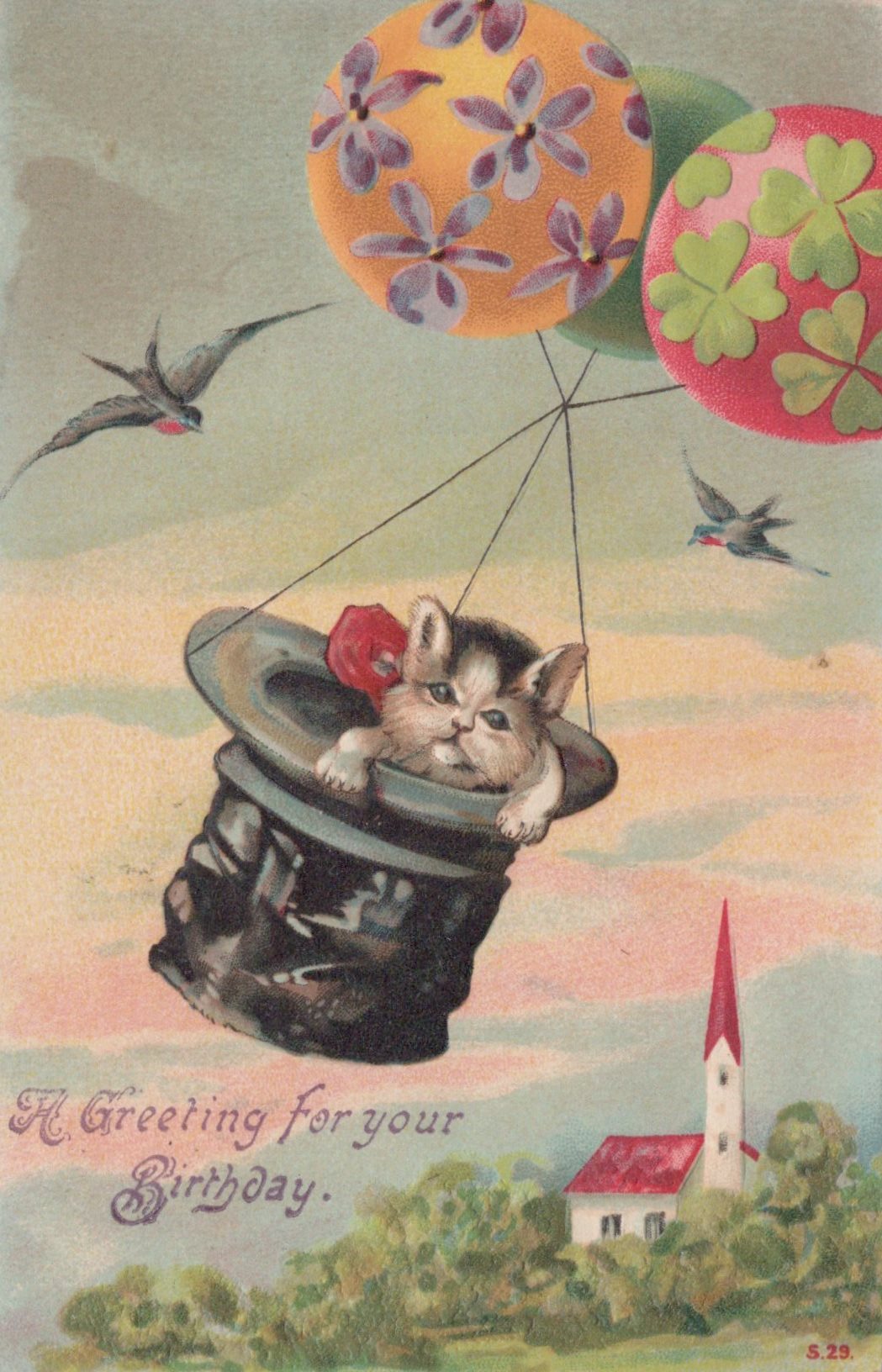 Vintage-style birthday postcard with a kitten in a top hat floating among balloons against a scenic background.