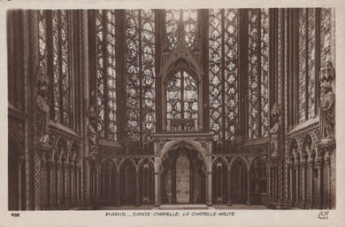 Gothic interior of Sainte-Chapelle with intricate stained glass windows.