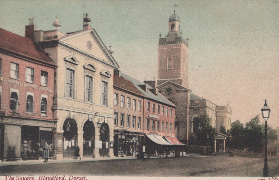 Vintage postcard of a town square with a clock tower and buildings.