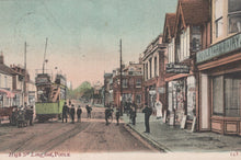Load image into Gallery viewer, Vintage street scene with a tram and pedestrians in Poole, featuring shops and buildings.
