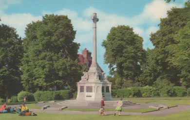 Memorial monument in a park with people around, trees in the background