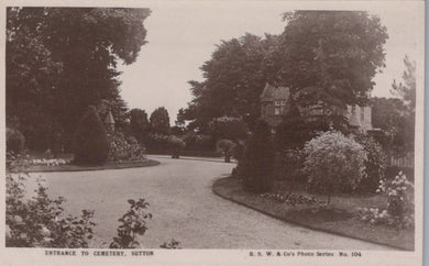 Vintage black and white photograph of a garden with trees and a building