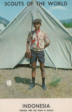 Scout standing in front of a tent with 'Scouts of the World' and 'Indonesia' text.