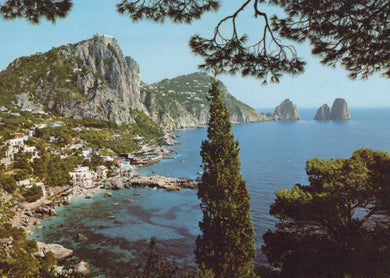 Scenic view of a coastal town with mountains and clear blue water