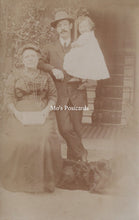 Load image into Gallery viewer, Vintage sepia-toned photograph of a family posing outdoors.
