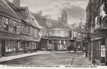 Load image into Gallery viewer, Vintage black and white photo of a street scene with shops and pedestrians 
