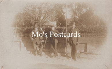 Vintage sepia-toned photo of three men with hand tools