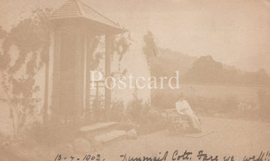 Vintage sepia-toned postcard with a gazebo and landscape