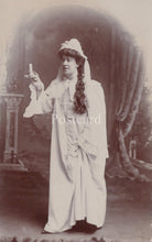 Load image into Gallery viewer, Vintage photograph of a woman in a white dress with a veil, holding a cigarette, on a postcard.
