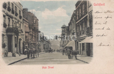 Vintage postcard of a street scene in Guildford, featuring buildings and people on a street.