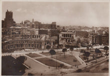 Load image into Gallery viewer, Vintage black and white photograph of a cityscape with historical buildings and a large open square.
