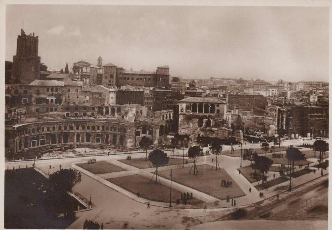 Vintage black and white photograph of a cityscape with historical buildings and a large open square.