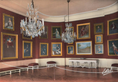 Stately room with portraits on the walls and chandeliers hanging from the ceiling.