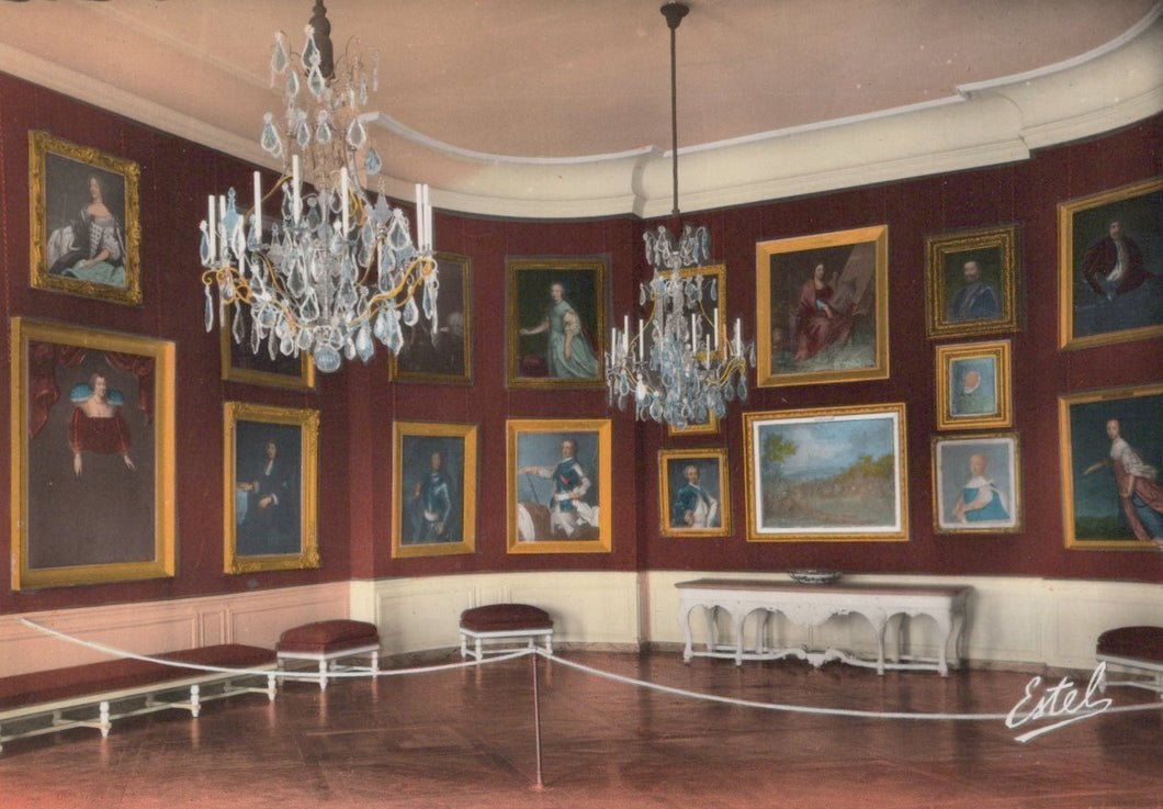 Stately room with portraits on the walls and chandeliers hanging from the ceiling.