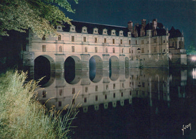 Castle reflected in water at night