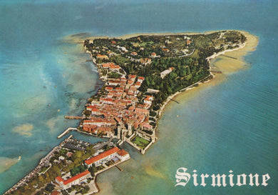 Aerial view of Sirmione on an island with clear blue water.