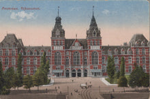 Load image into Gallery viewer, Vintage postcard of the Rijksmuseum in Amsterdam with a red brick building and green trees.
