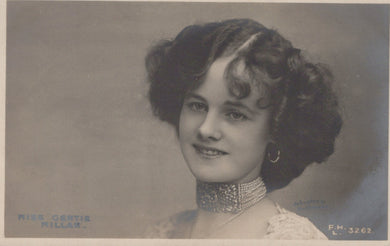 Vintage black and white portrait of a woman with styled hair and jewelry.