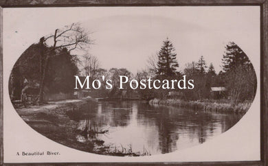 Vintage-style black and white photo of a river with trees 