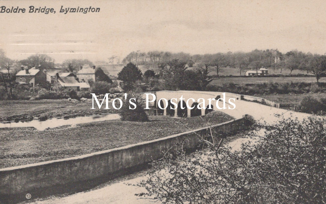 Vintage black and white photo of a bridge over a river with buildings in the background 