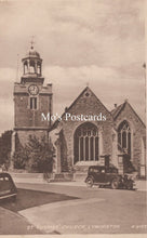 Load image into Gallery viewer, Vintage postcard of St. Thomas Church in Lymington with a clock tower and old car.
