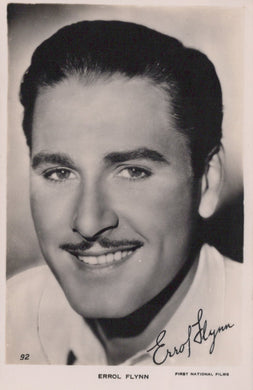 Vintage black and white portrait of Errol Flynn with a signature at the bottom.